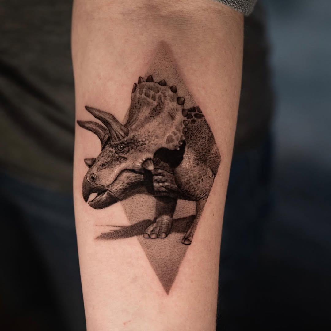 Single-needle triceratops with dotwork shading on forearm