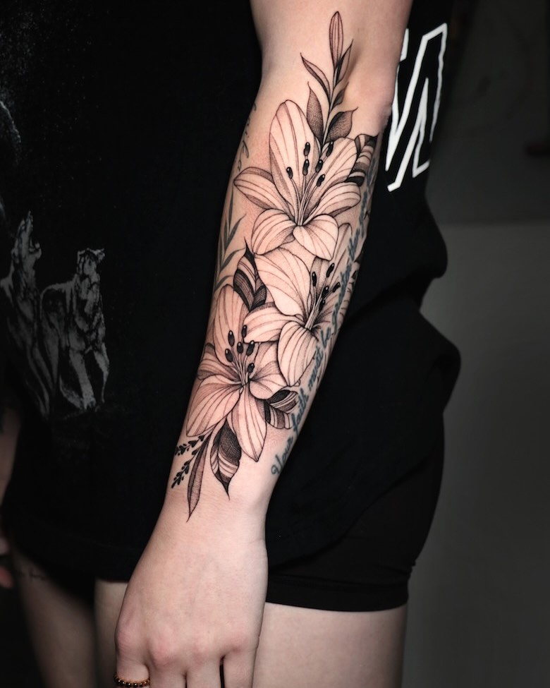 Delicate fine-line lilies wrapping the forearm with shading
