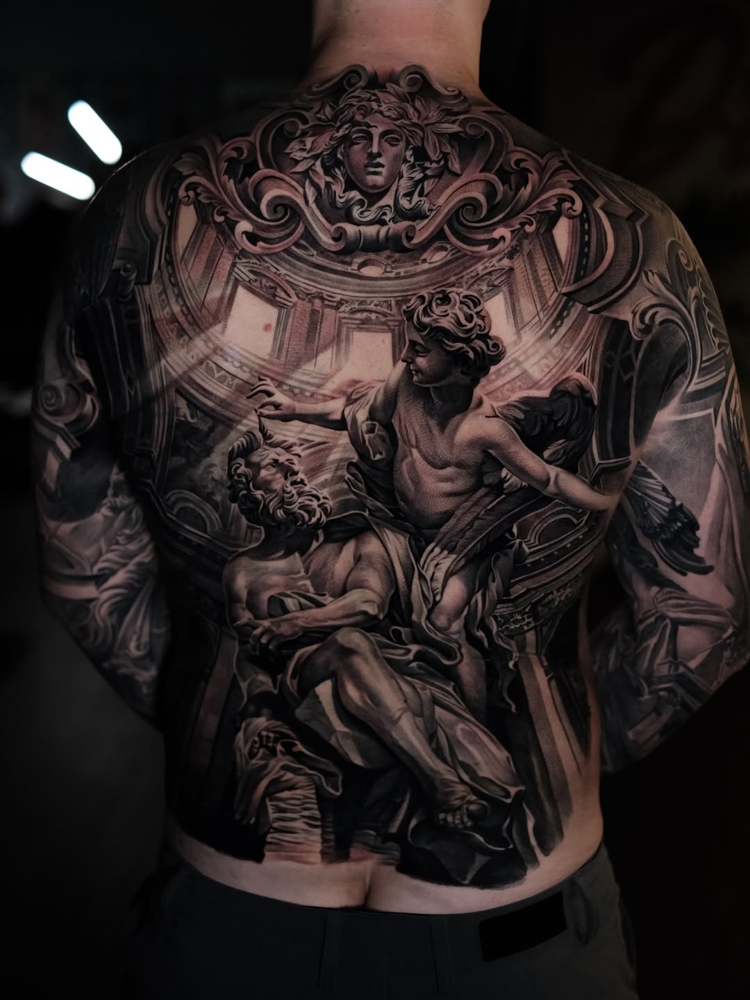 Monumental black-and-gray backpiece with classical sculpted figures