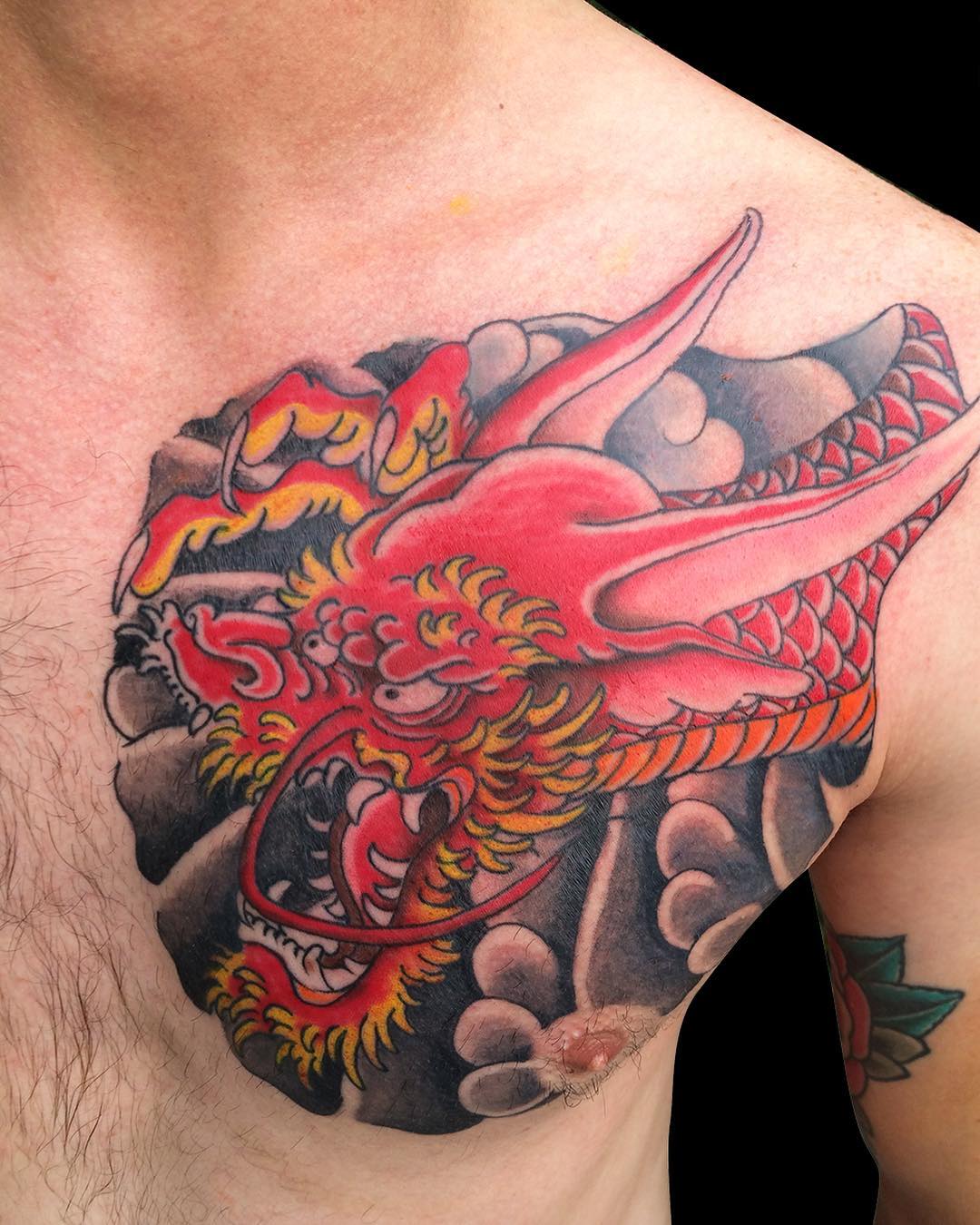 Colorful dragon chest tattoo