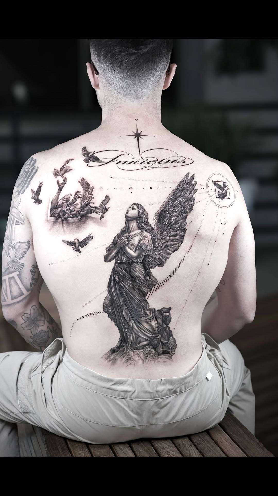 Detailed angel and bird tattoo