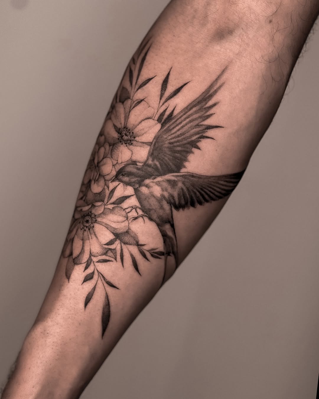 Swallow gliding among blossoms in detailed black-gray shading