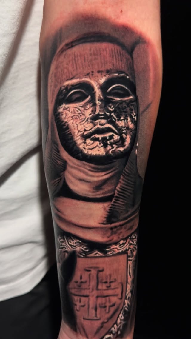 Monolithic grayscale mask bust with hooded cloak, dramatic shading