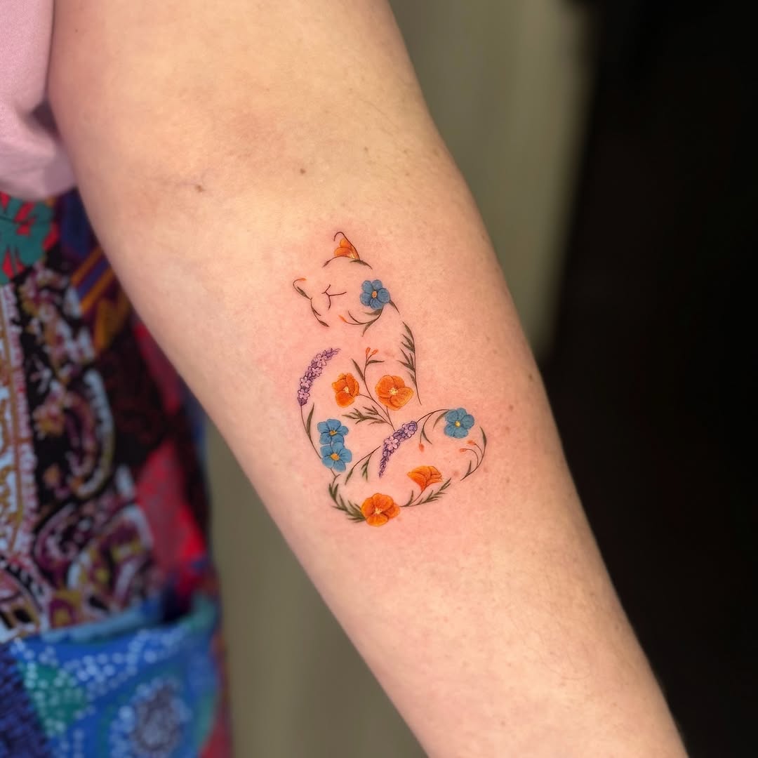 Delicate floral fineline on forearm, airy and colorful