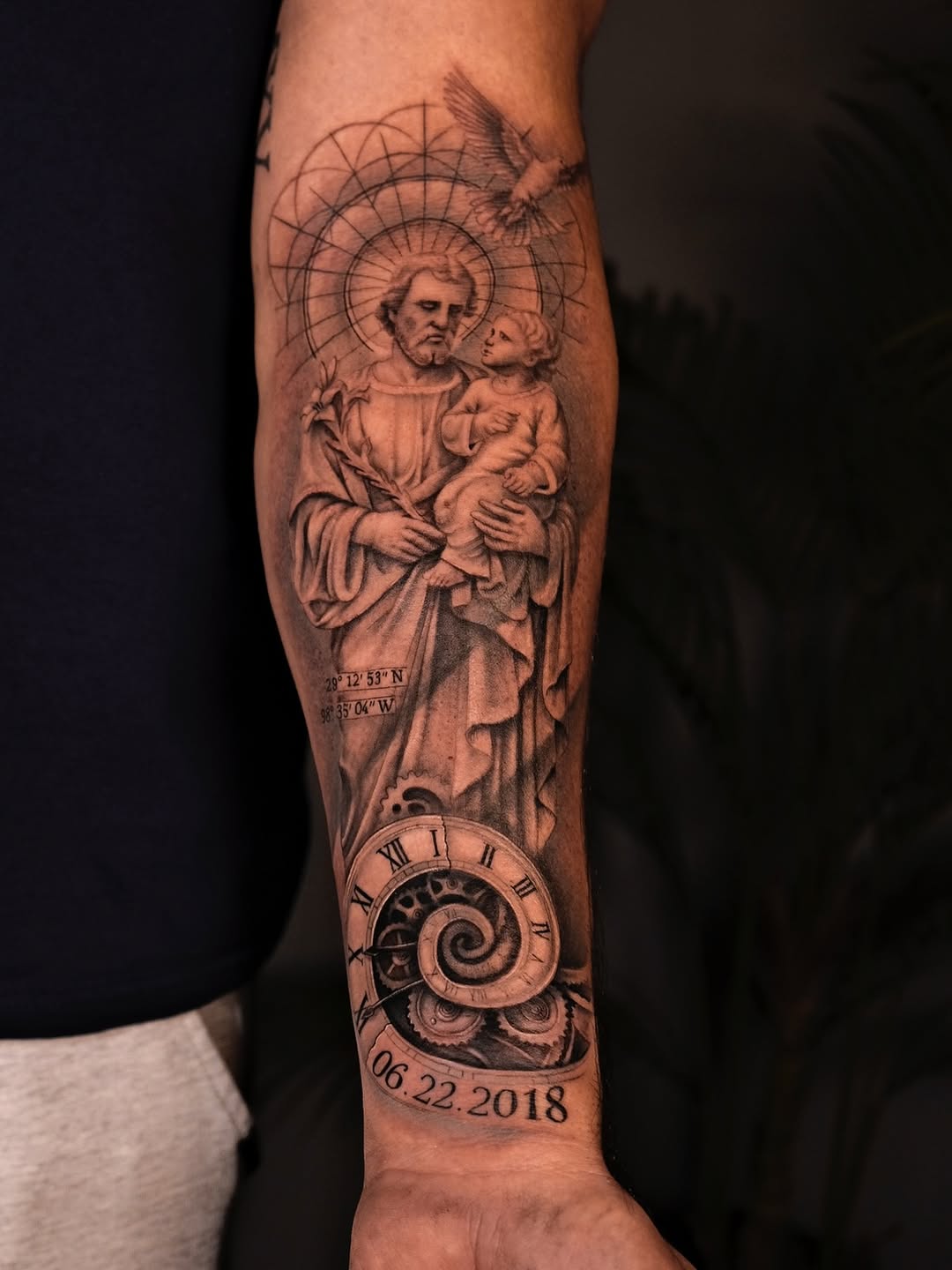 Intricate grayscale religious sleeve: saint with child, halo, clockwork spiral