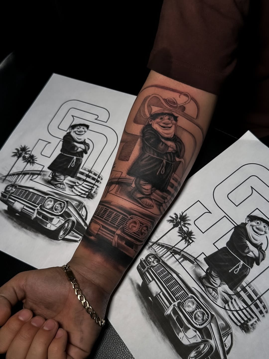 Bold black-and-gray realism of cartoonish retro gangster on forearm