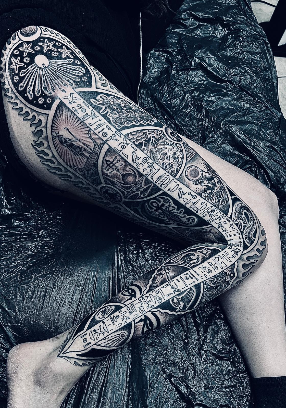 Intricate black-and-grey cosmic sleeve with medallions