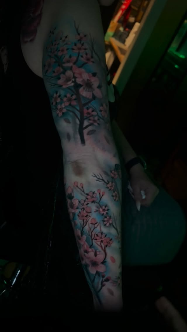 Watercolor cherry blossoms on blue-toned sleeve