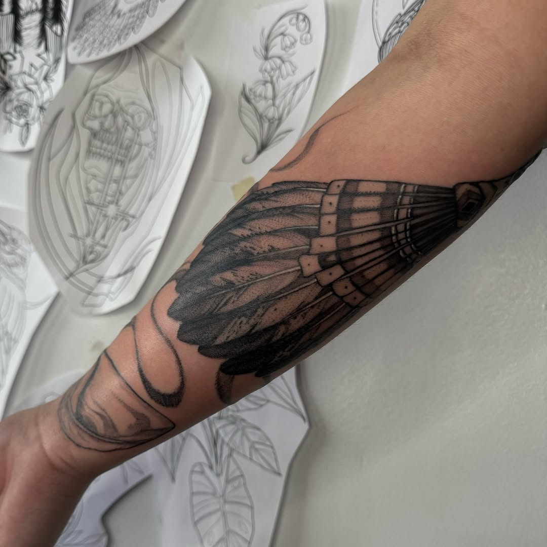 Bold black feather wing with layered vanes and shading