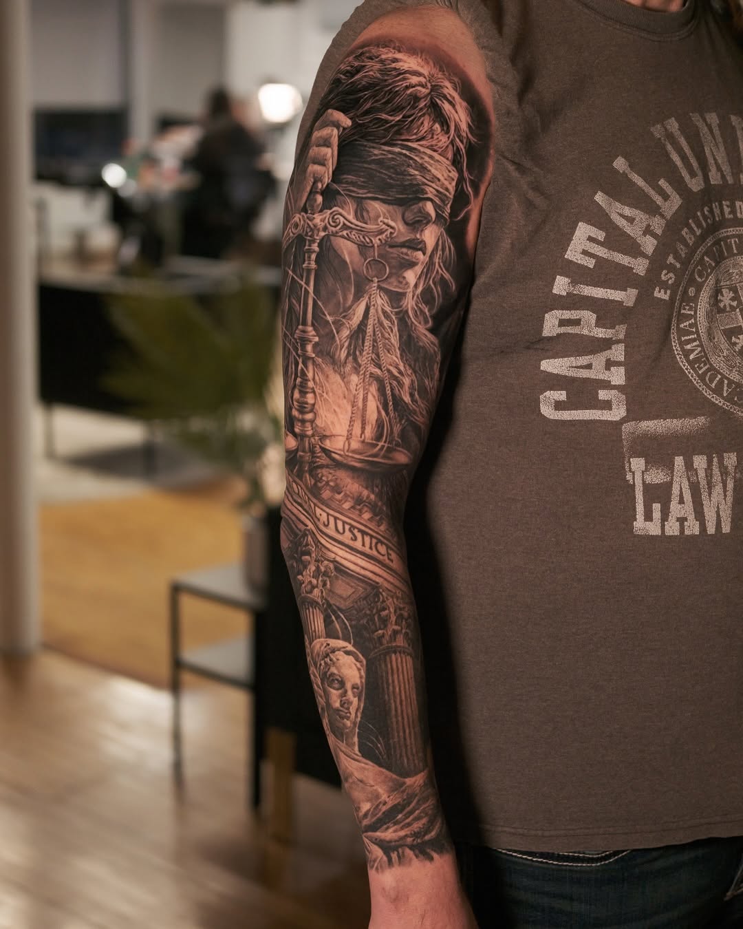 Hyper-detailed black-and-gray sleeve featuring Lady Justice and architecture