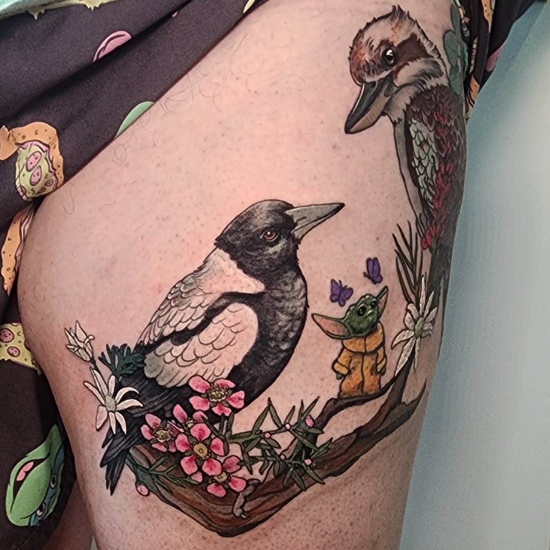 Playful kookaburra and magpie amid blooming flowers with Grogu.