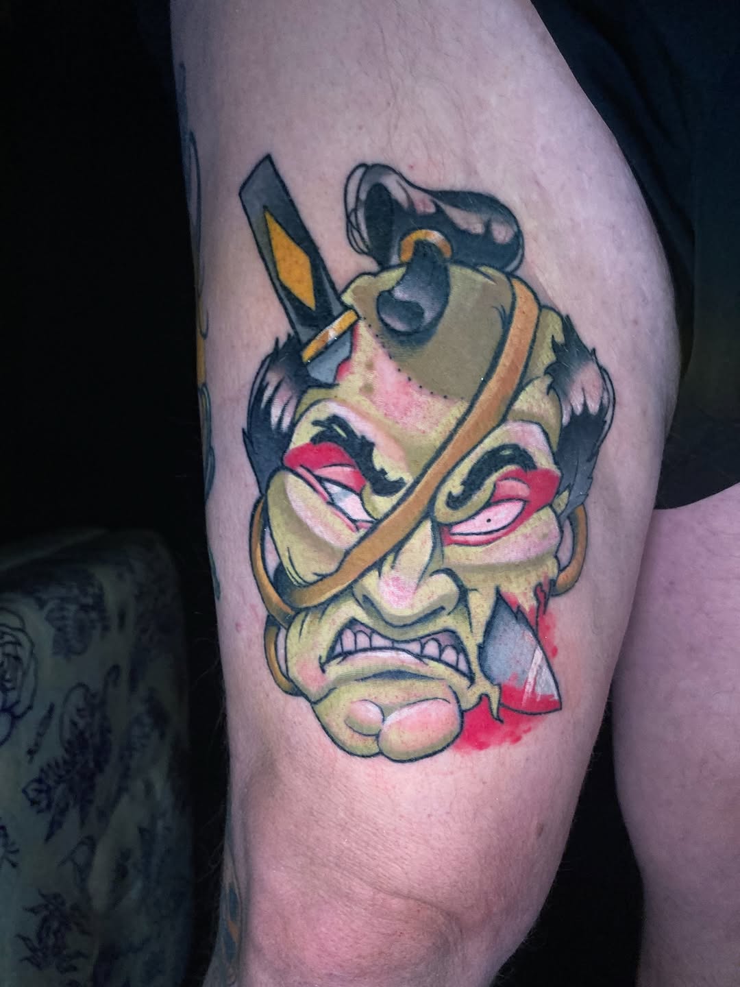 Vivid namakubi Oni mask with intense red eyes and sword