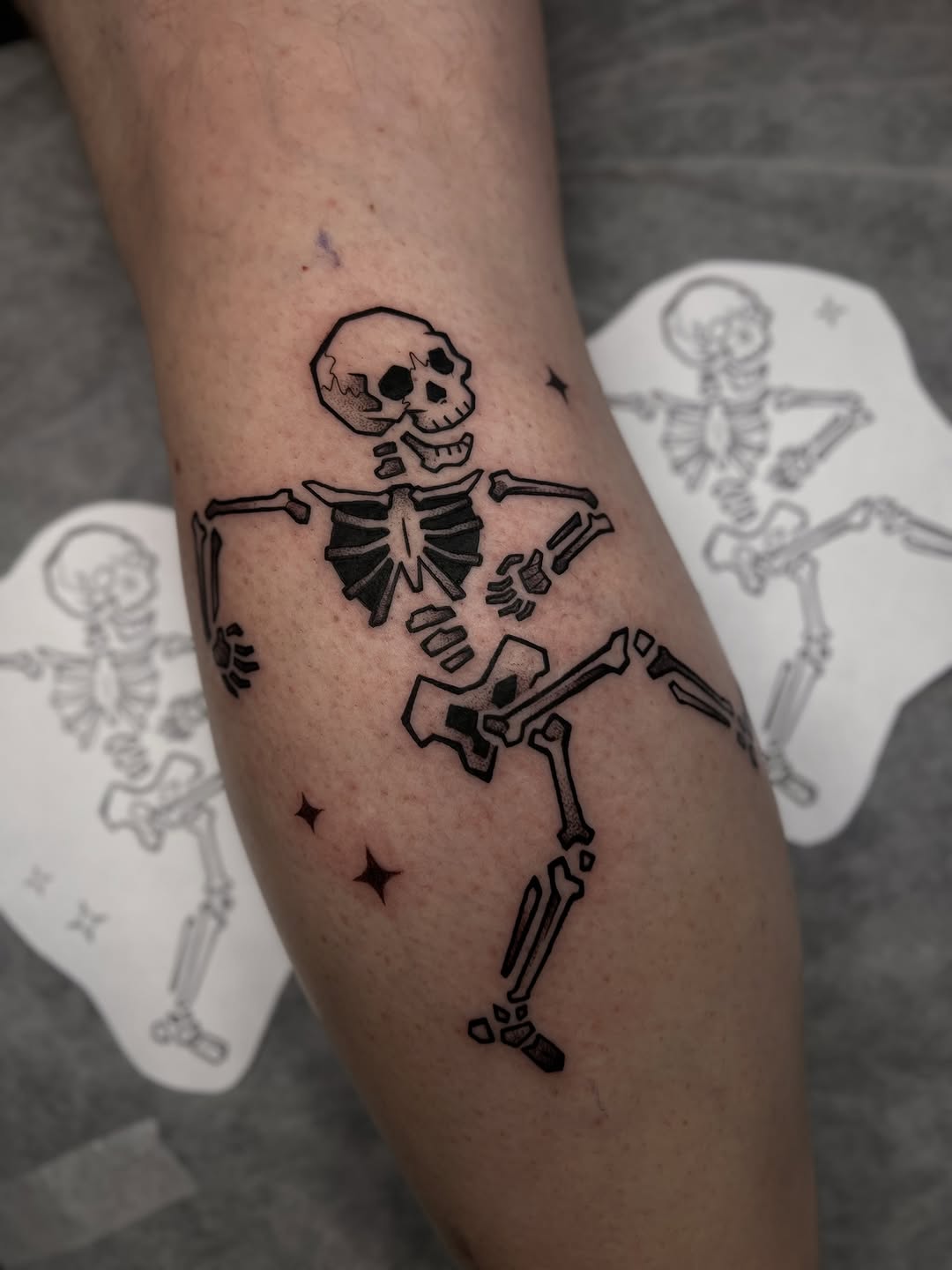 Playful dancing skeleton in bold blackline with star accents