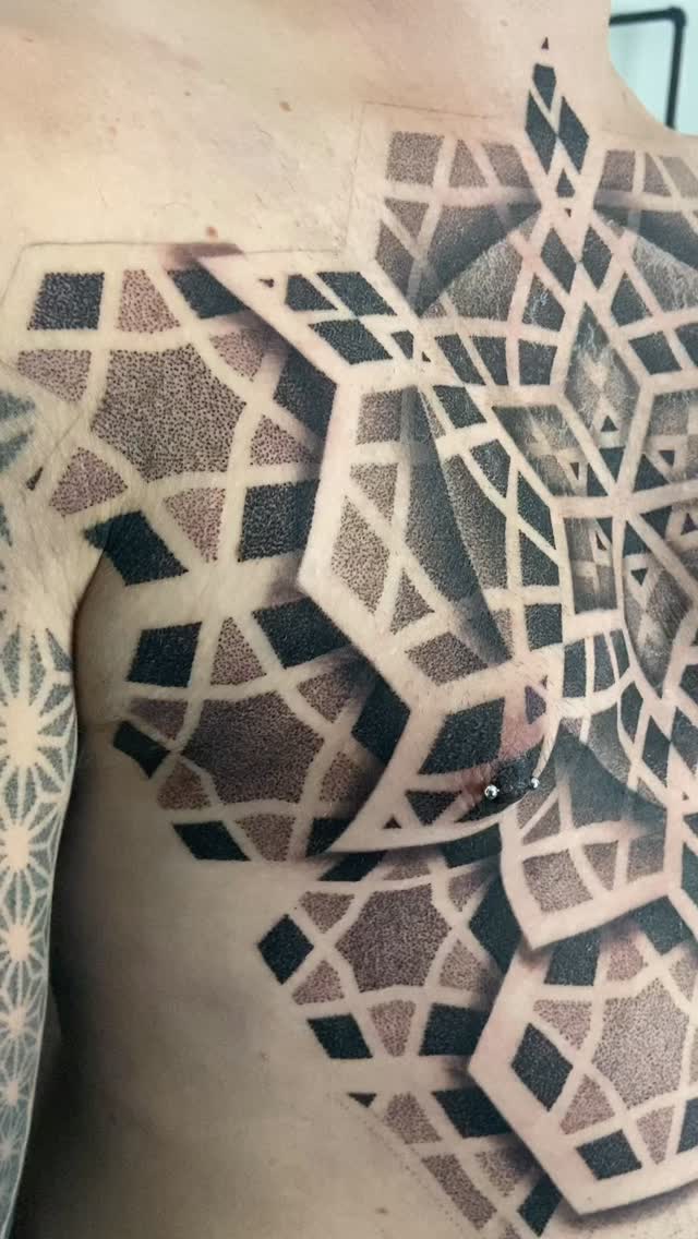 Massive dotwork geometric chest piece with crisp negative space