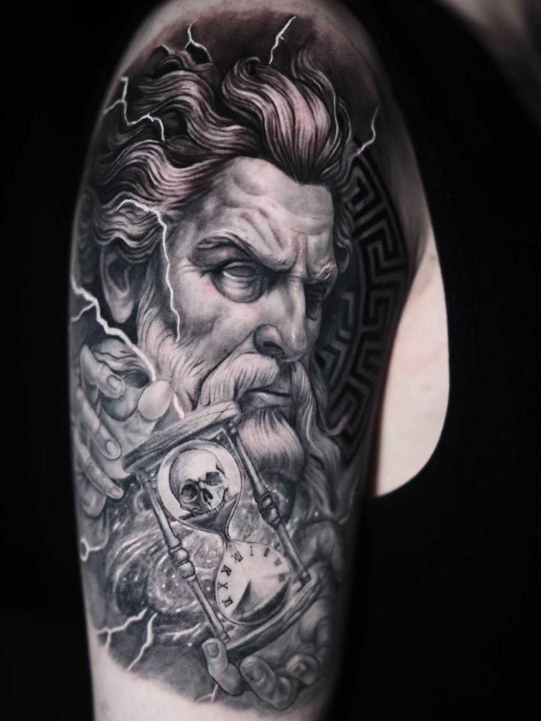 Monumental black-and-gray Zeus bust with crackling lightning