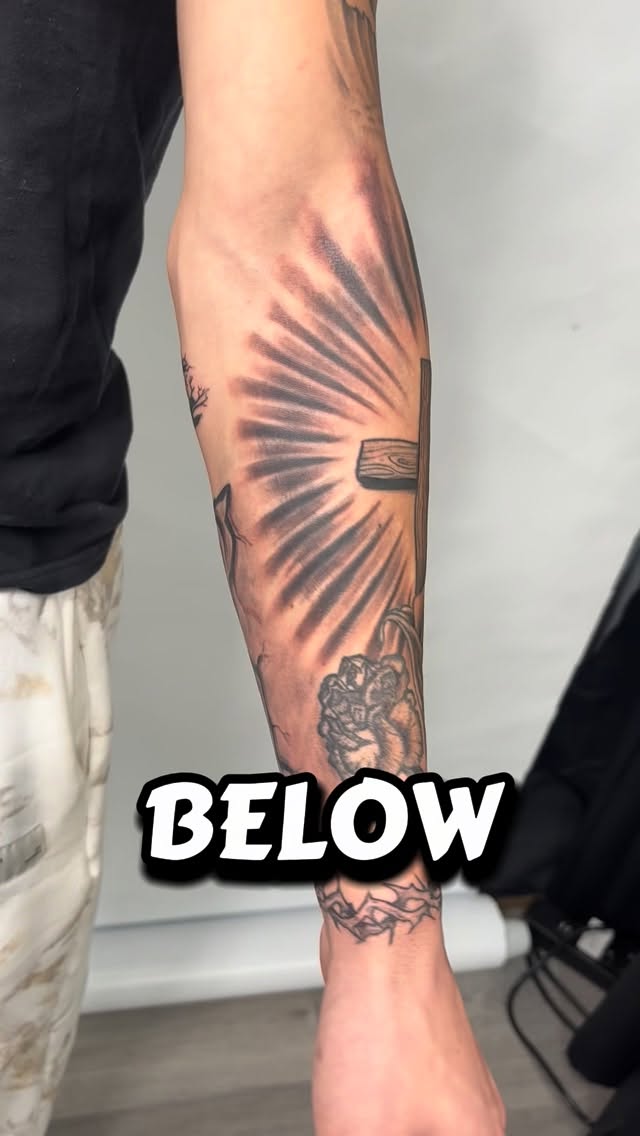 Bold blackwork sunburst behind a cross on forearm