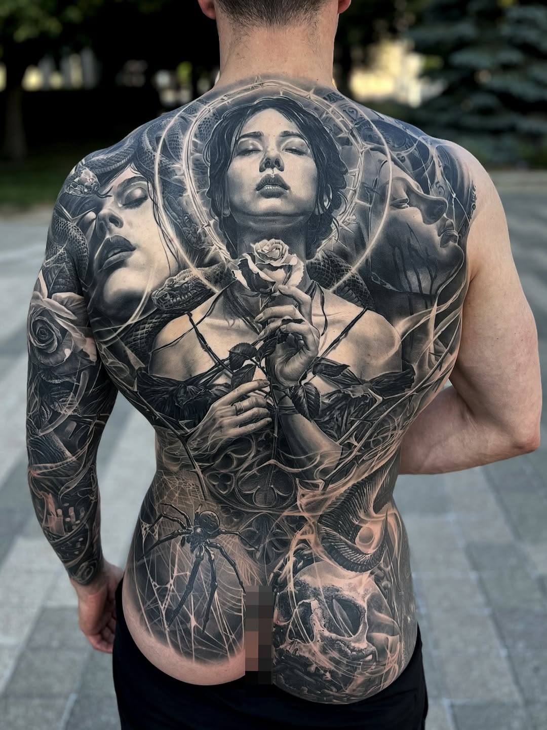 Monumental grayscale back piece featuring ethereal female visage and roses