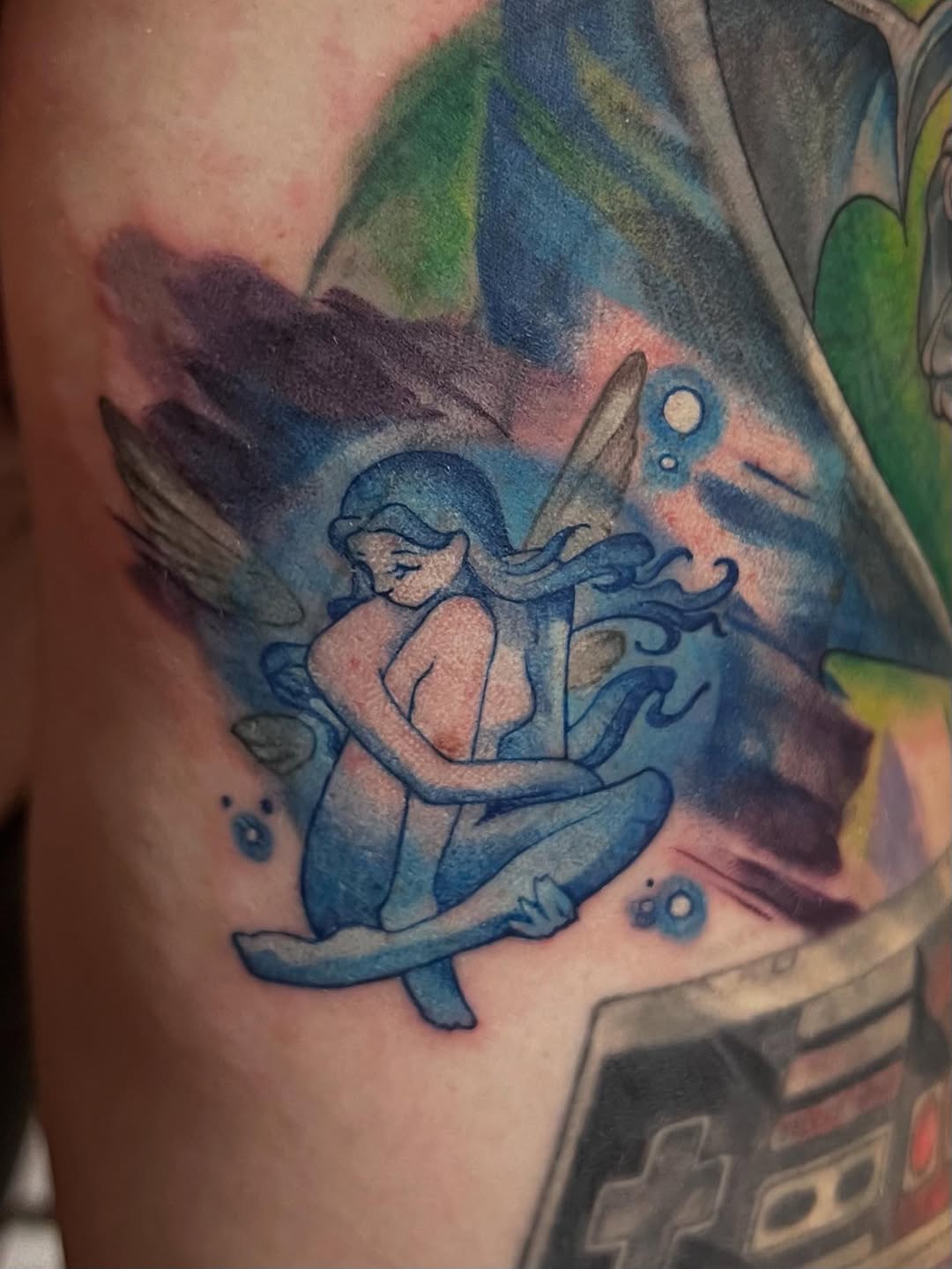 Luminous blue Navi fairy perched amid dreamy aquatic swirls