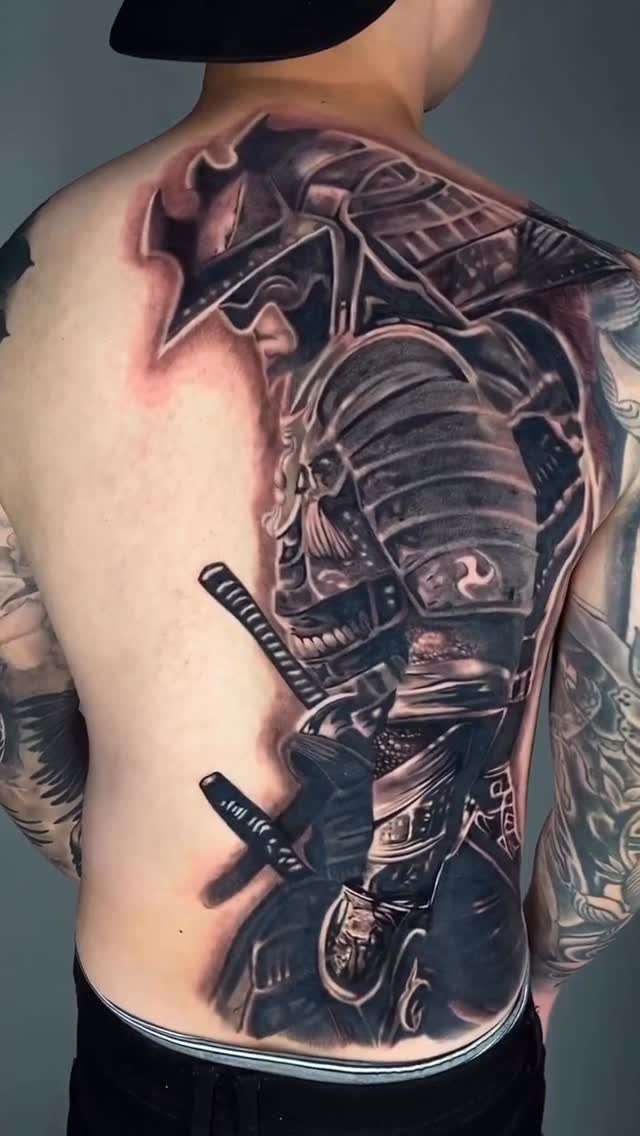 Monumental black-and-gray samurai armor back piece with dual katanas