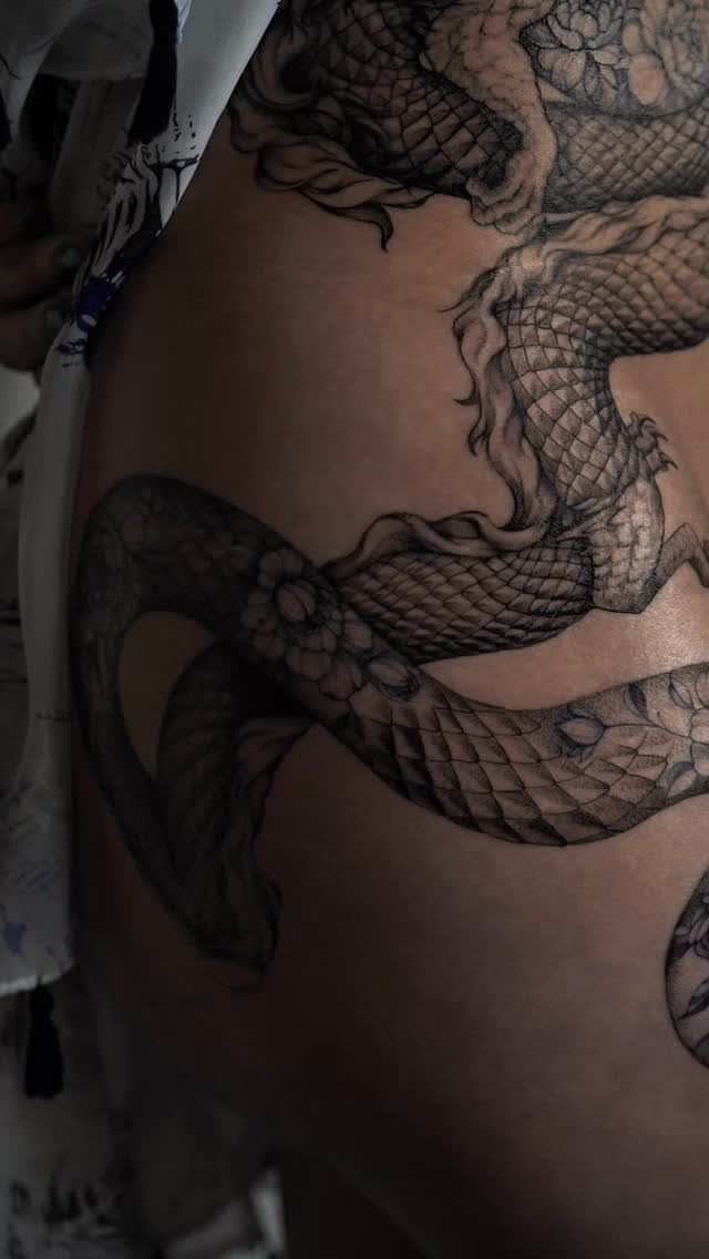 Coiled dragon with bold linework wrapping the torso