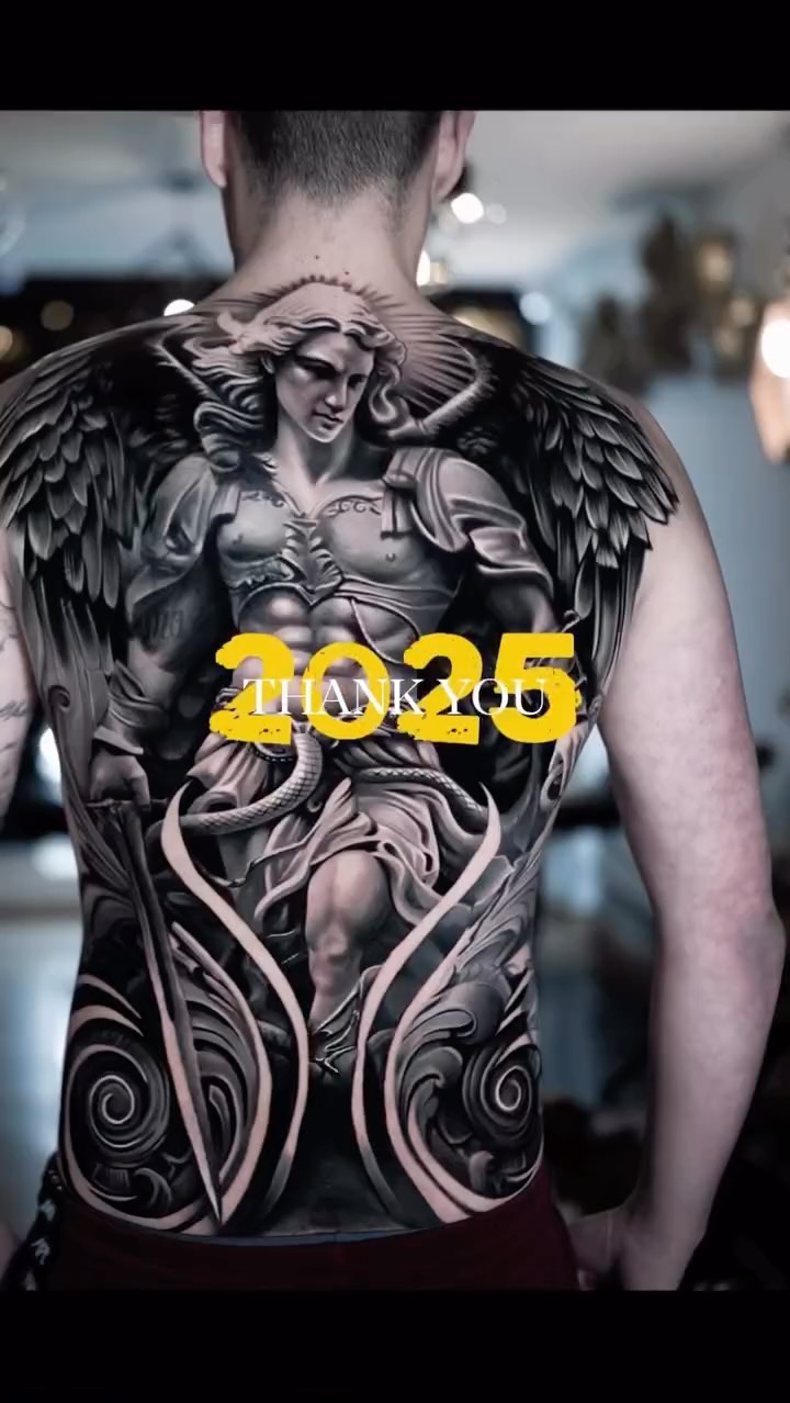 Imposing black-and-gray angel with massive wings