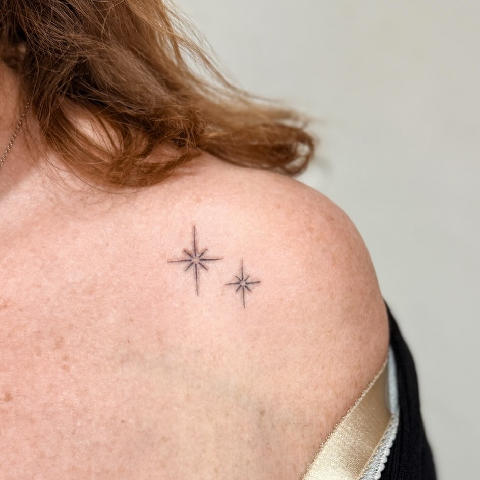 Delicate twin star outlines in fine-line minimalist style