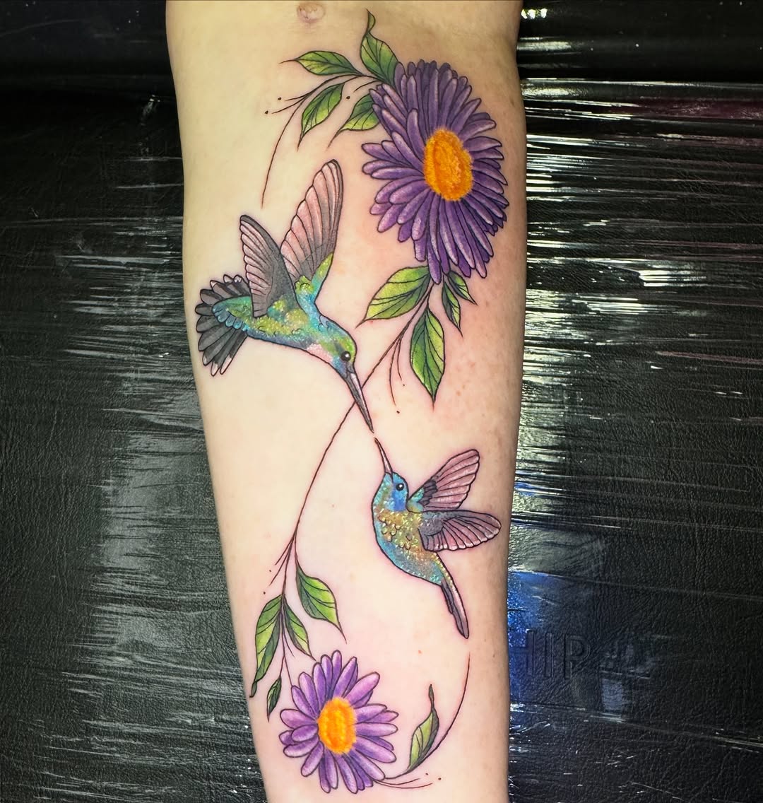 Vibrant hummingbirds among purple daisies in watercolor