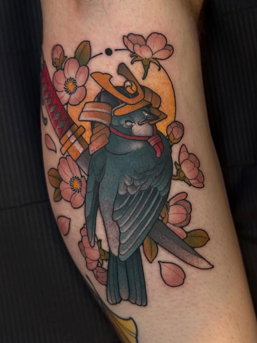 Bold neo-traditional parrot wearing samurai helmet among sakura.