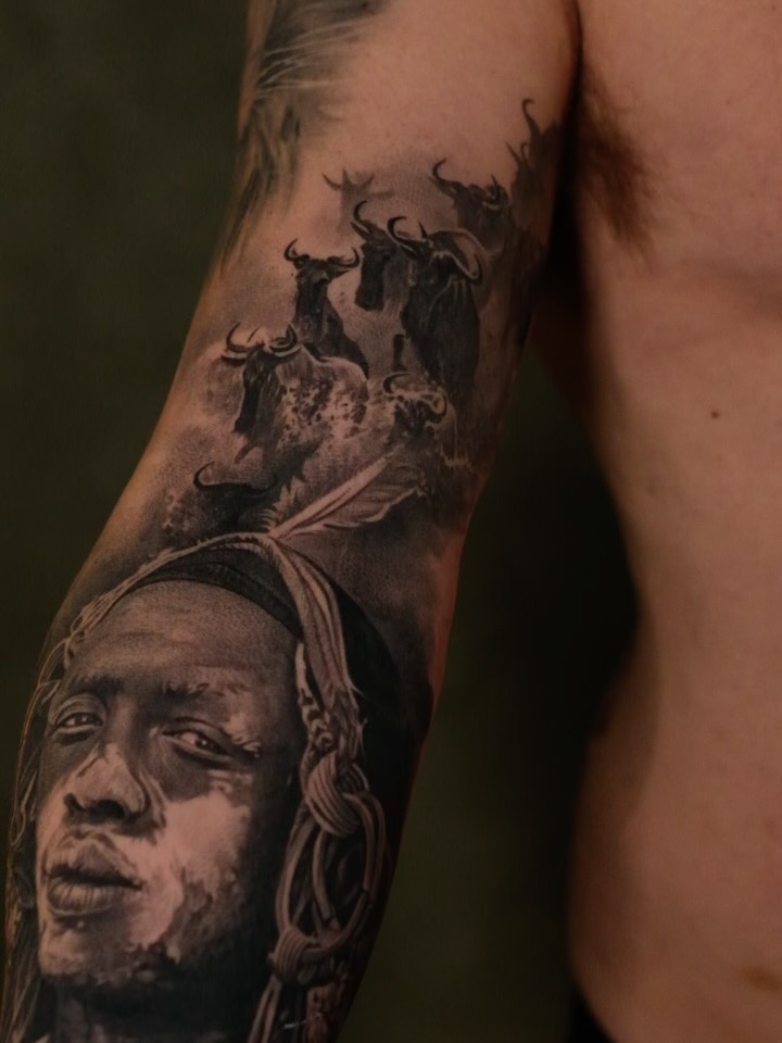 Hyper-detailed black-and-gray portrait on forearm with headwrap