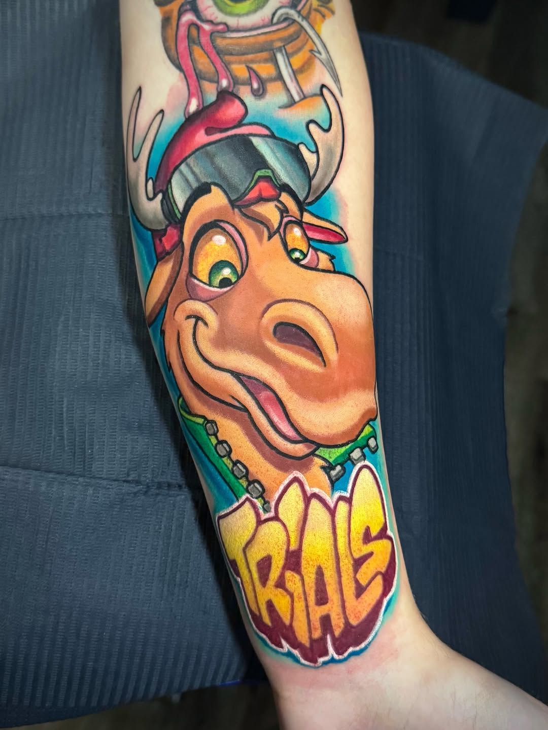 Bold, colorful cartoon dinosaur head with Viking horns