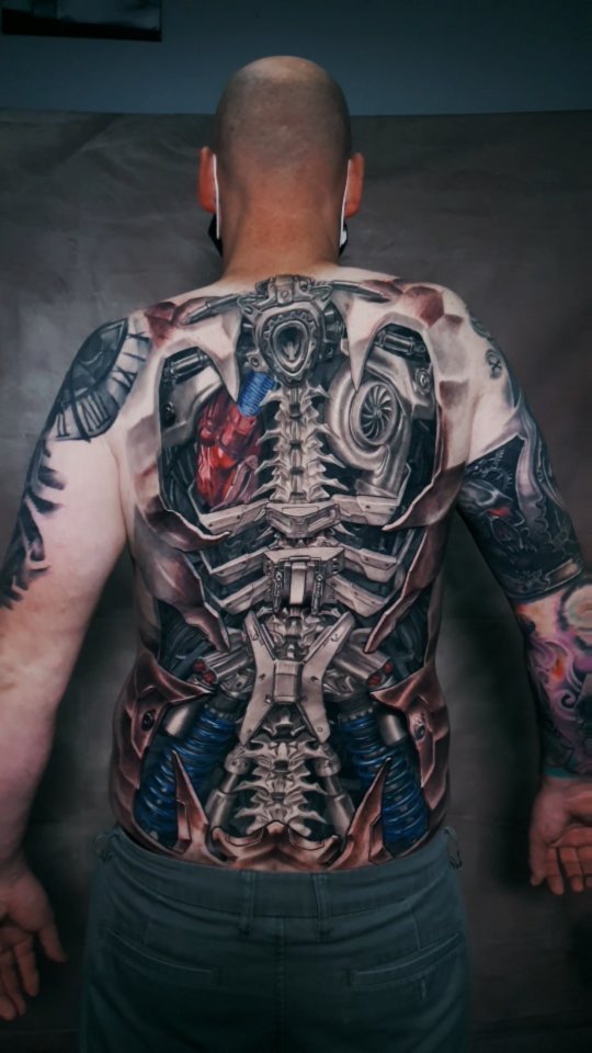 Hyper-detailed biomechanical back piece with spine-centric architecture