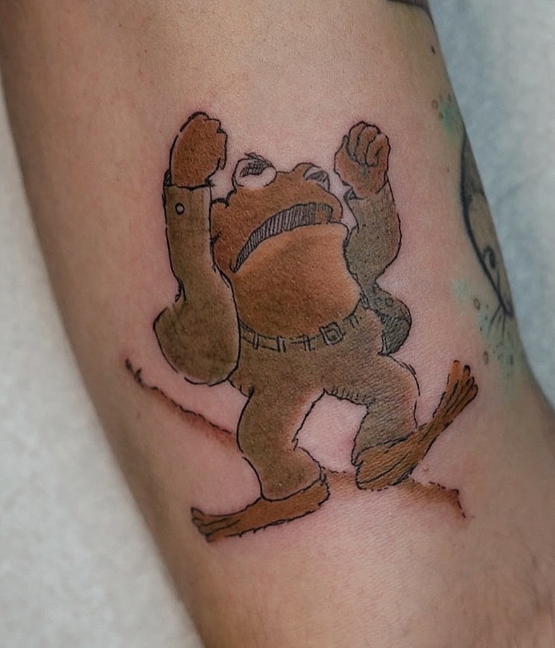 Whimsical cartoon toad with raised arms, bold outlines.