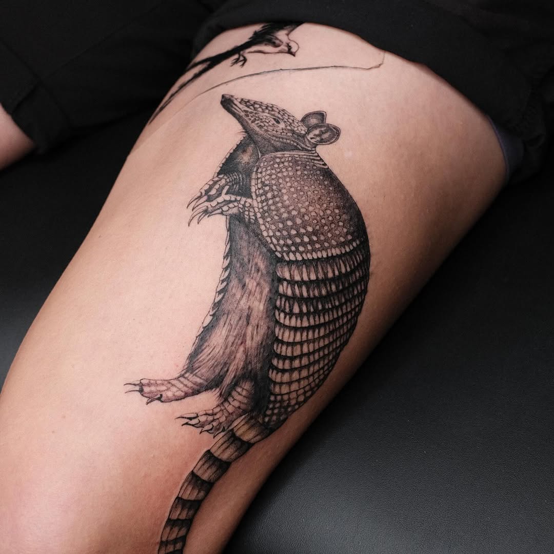 Intricate armadillo tattoo with dot-worked armor plates