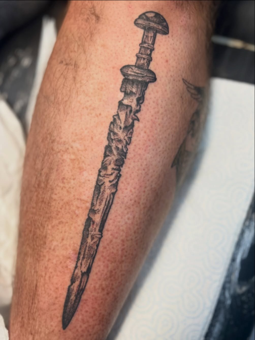 Bold black dagger with rugged, textured blade.