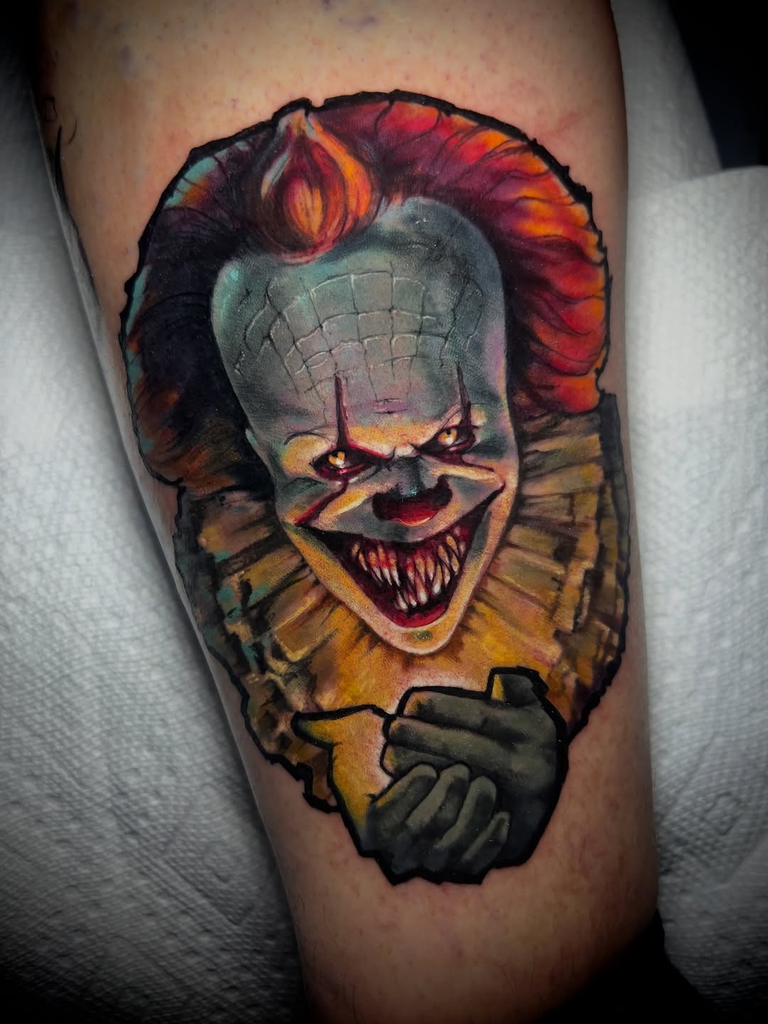 Vivid Pennywise clown with menacing grin, bold colorwork