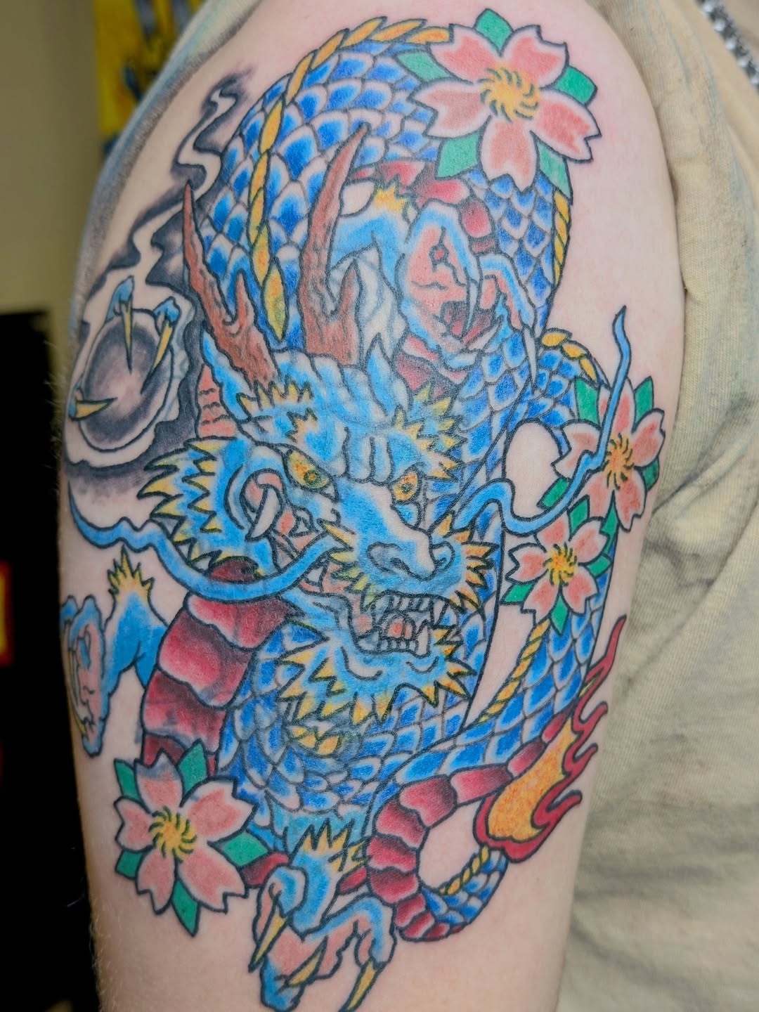 Vibrant Japanese dragon with cherry blossoms and stylized waves