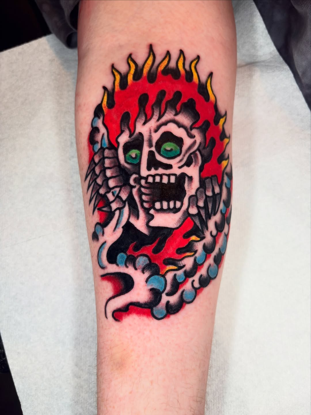 Bold skull in fiery halo with bright green eyes