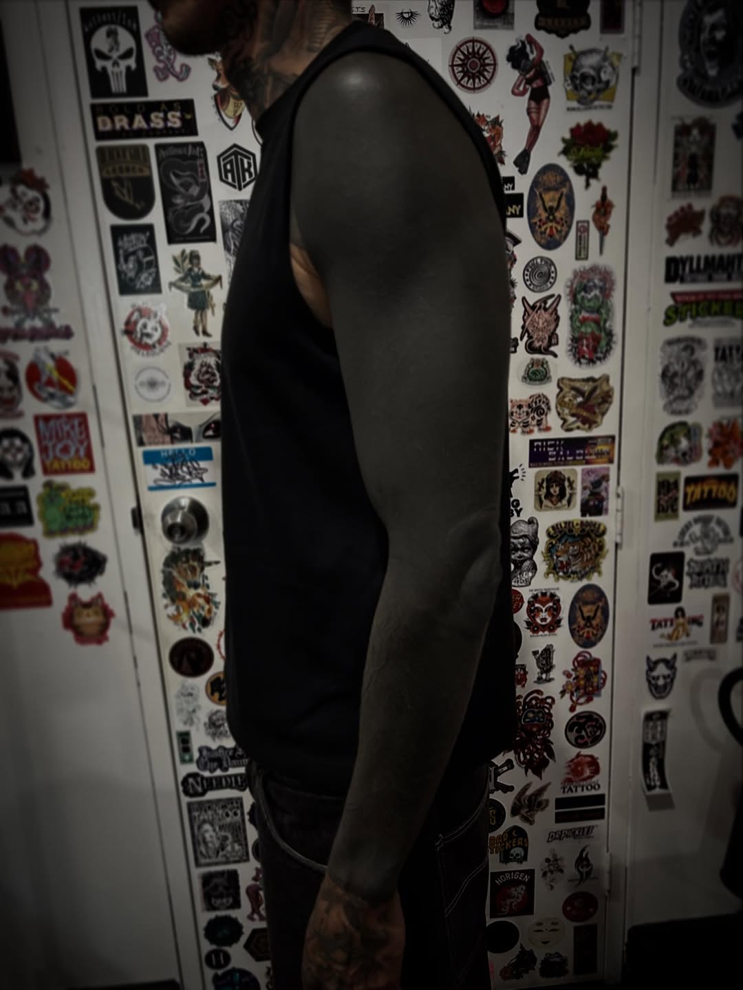 Solid black blackout forearm tattoo with elbow touch-up