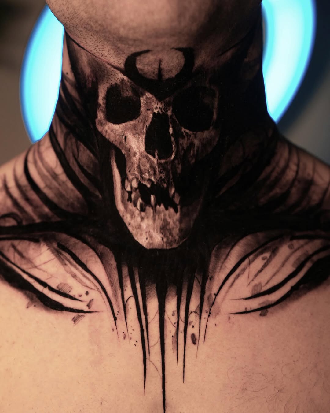 Surreal skull neck piece with bold blackwork shading.