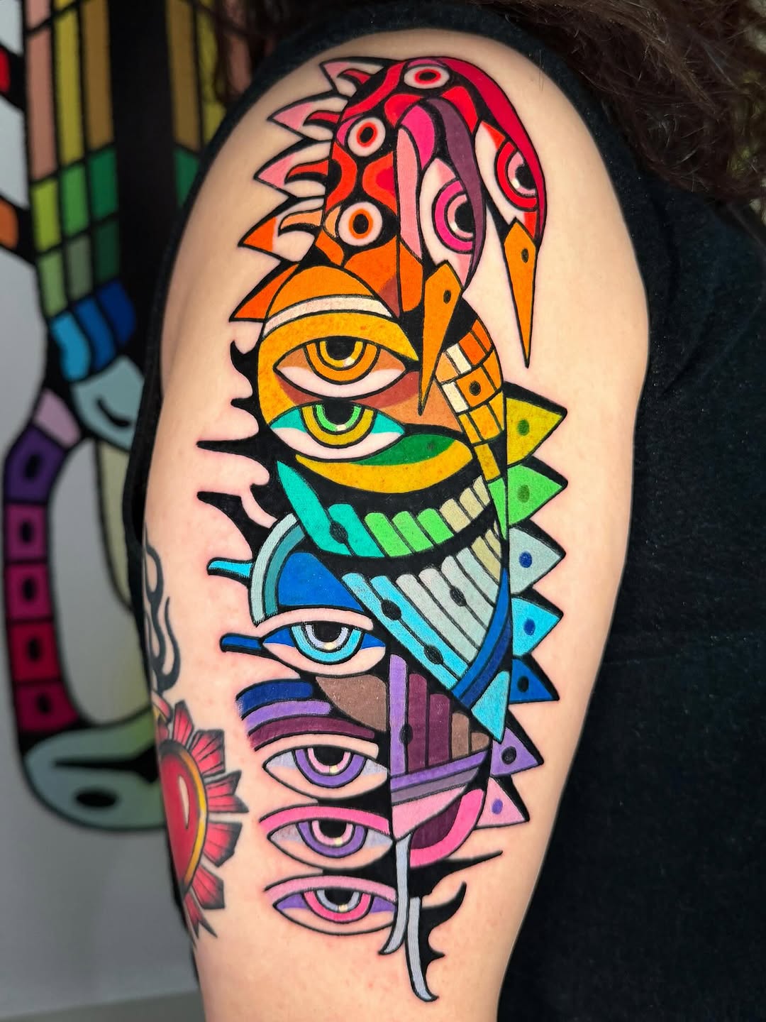 Vibrant stacked-eye bird composed of bold geometric shapes
