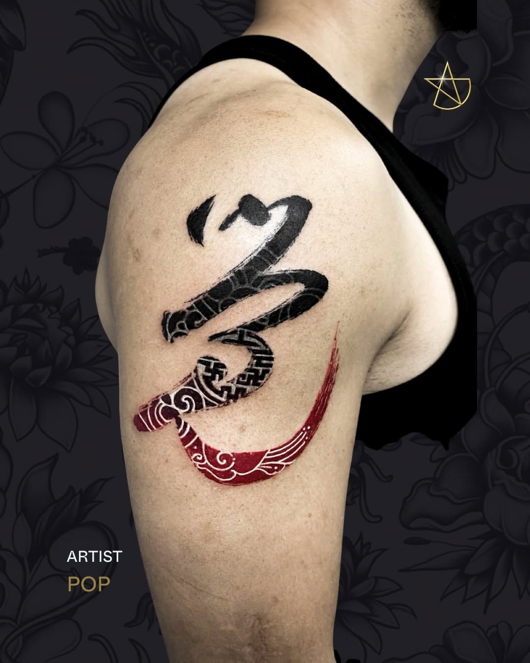 Dynamic black brushstroke tattoo with crimson ornamental scroll