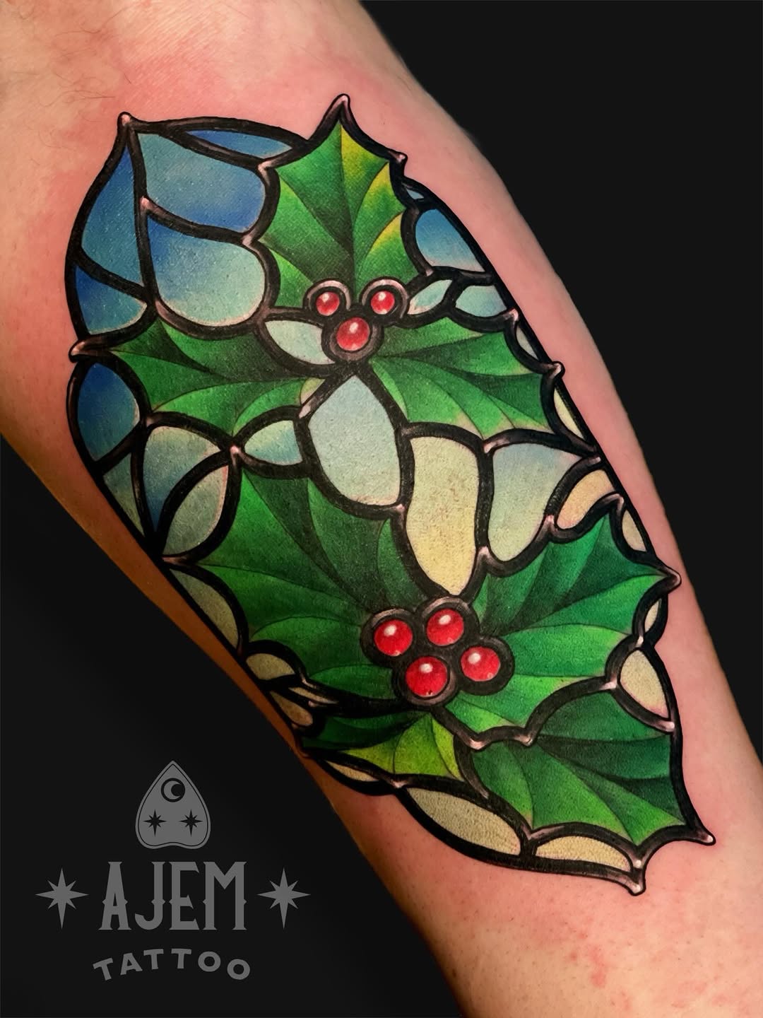 Vivid stained-glass holly with bold outlines.