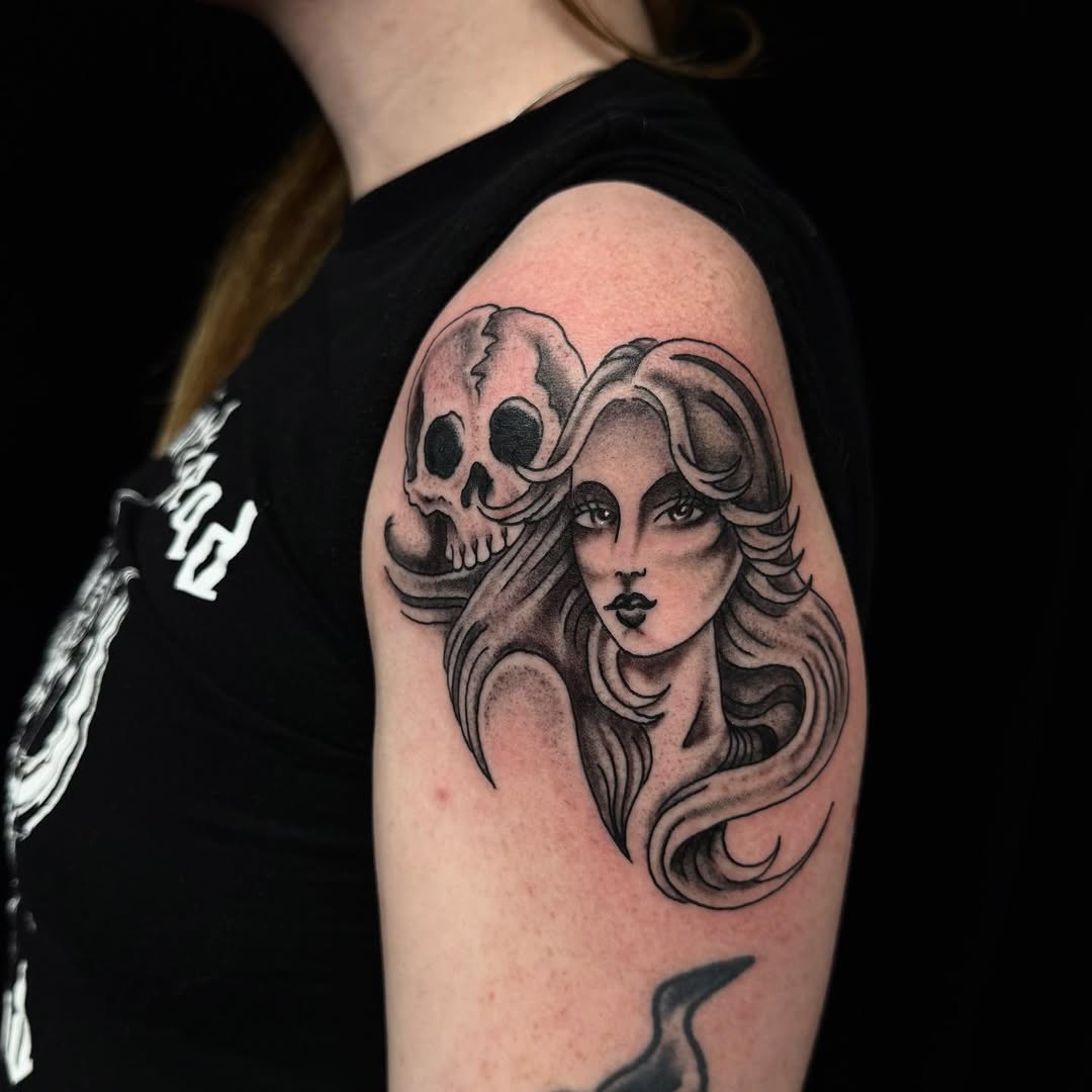 Bold grayscale femme portrait with a looming skull.