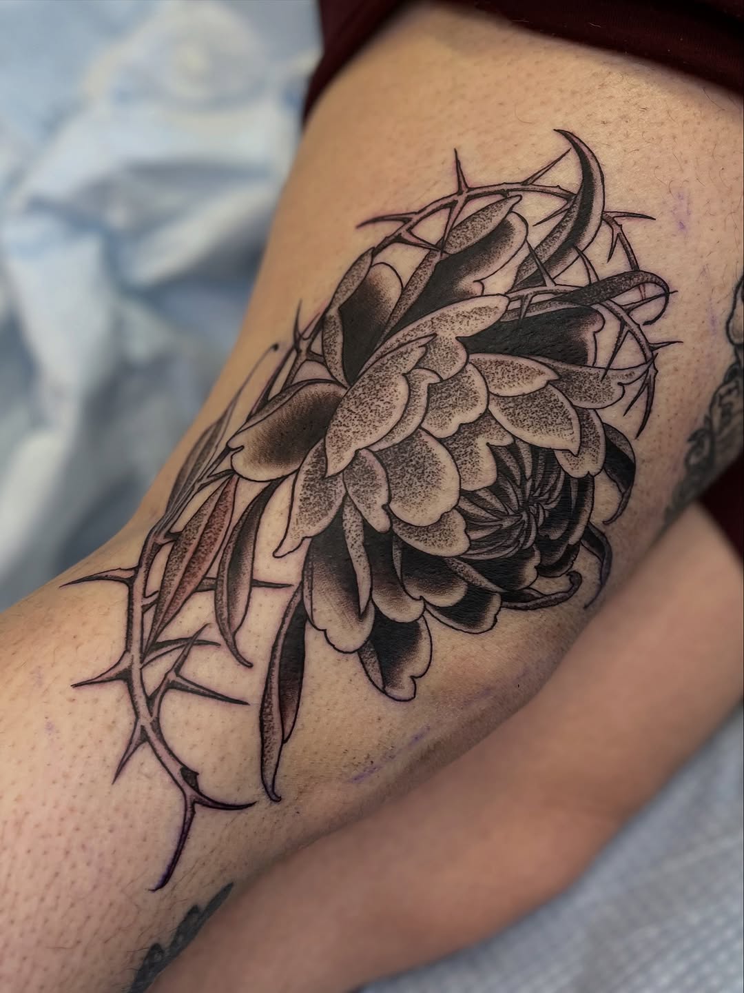 Bold blackwork floral cluster with dot-shaded petals