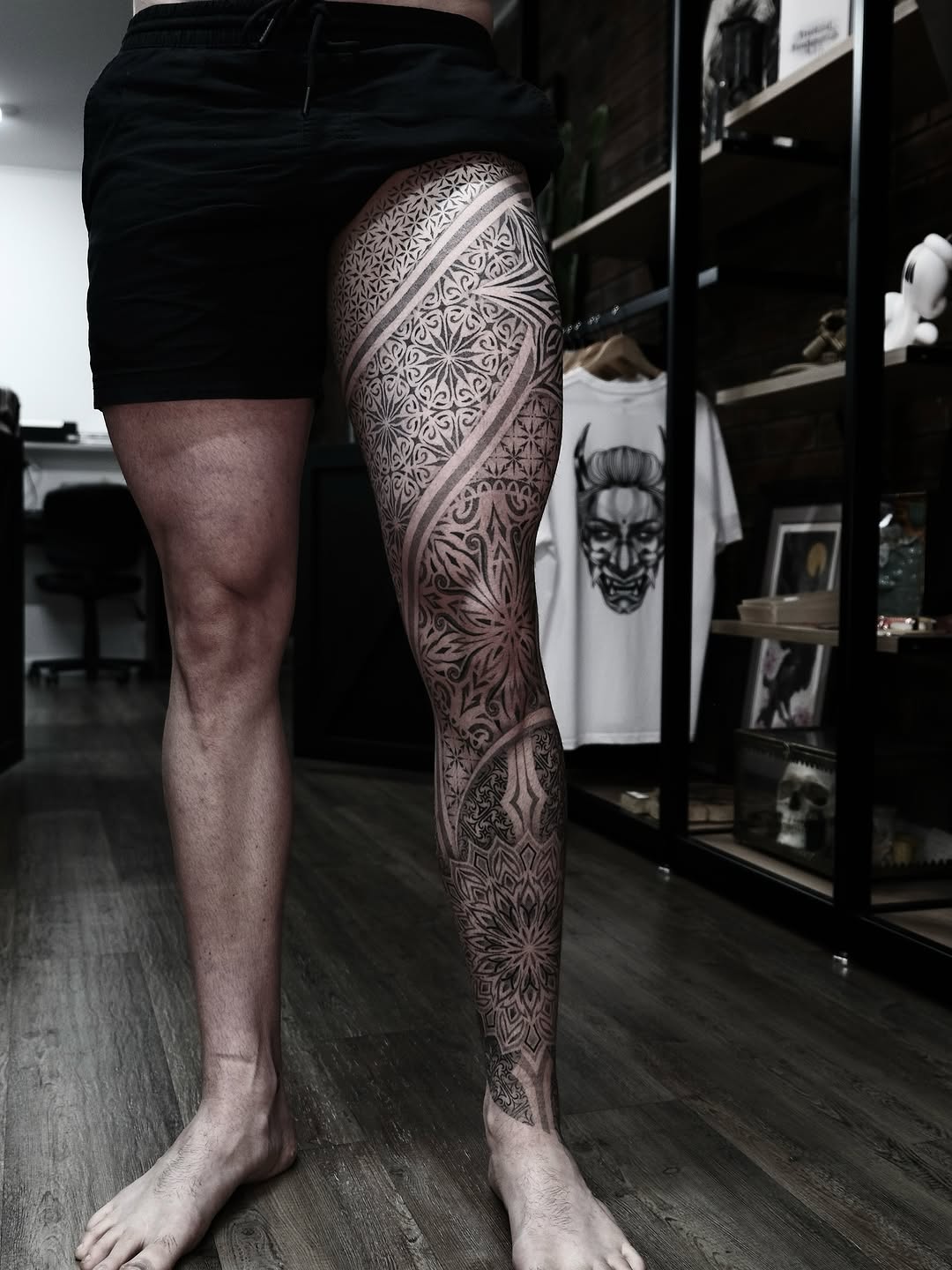 Intricate blackwork geometric leg sleeve with ornamental patterns