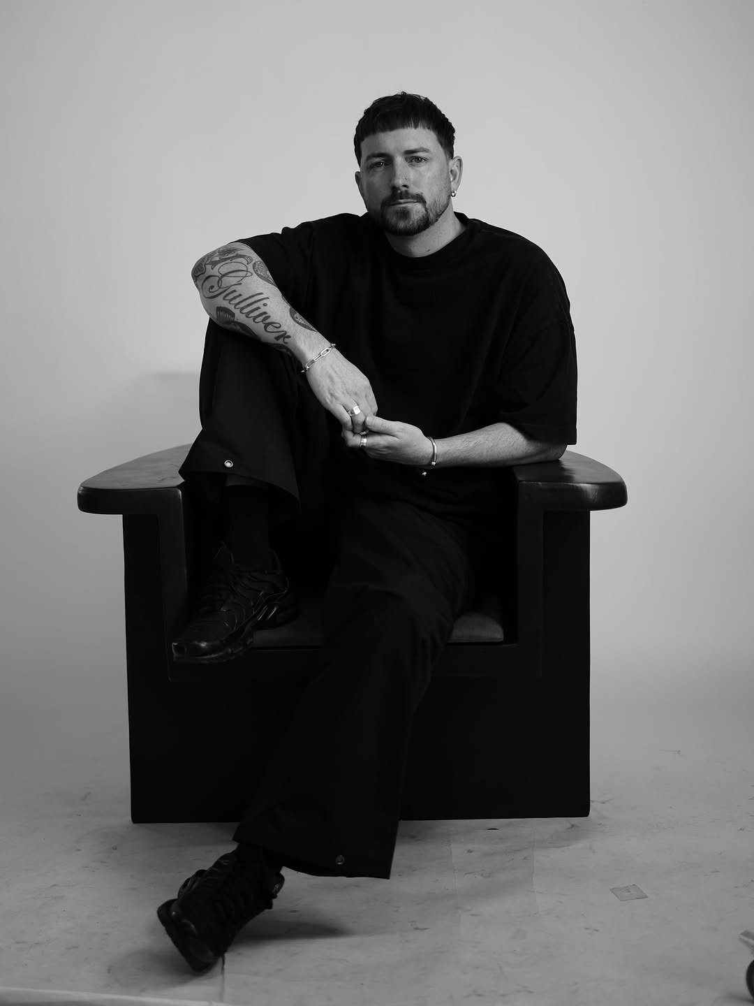 Bold script lettering on forearm with flowing cursive.