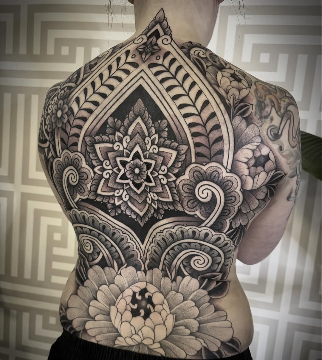 Intricate blackwork mandala back-piece with floral motifs