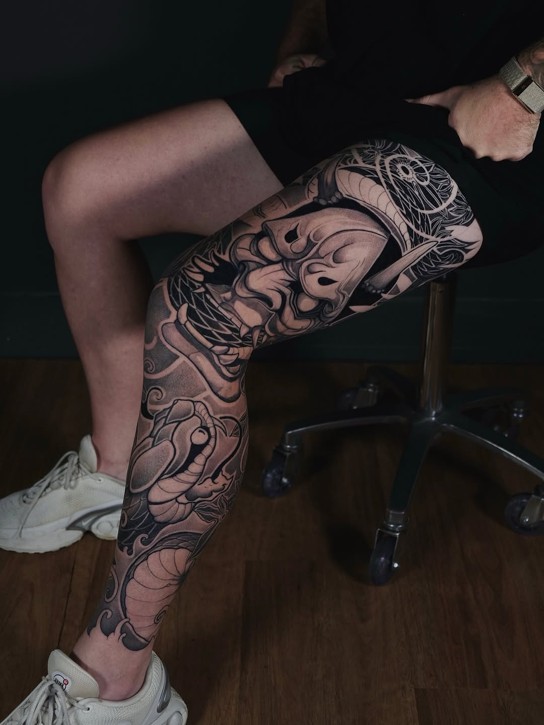 Bold black-and-gray leg sleeve with flowing beast motifs