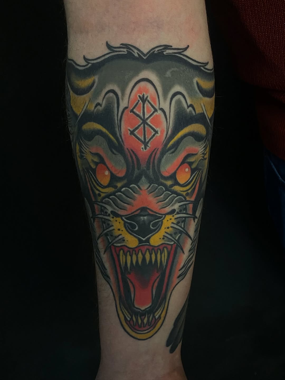 Neo-traditional beast head with bold colors and ferocious maw