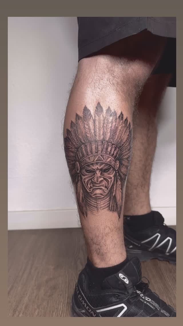 Bold black-and-gray Native American chief with feather headdress